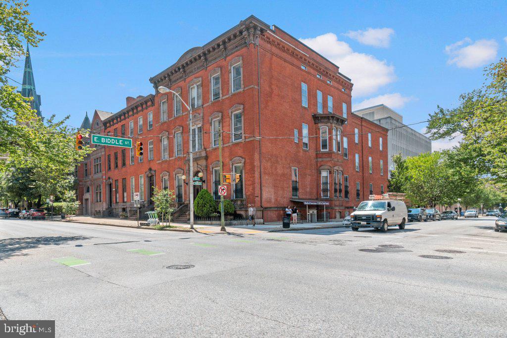 a car parked in front of a building with a street