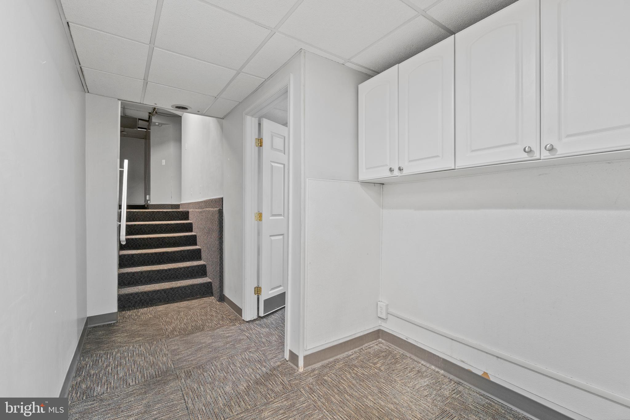 1118 St Paul Street, Unit 1 Baltimore, MD 21202 - Photo 8 of 8 a view of an empty room with stairs and ventilation