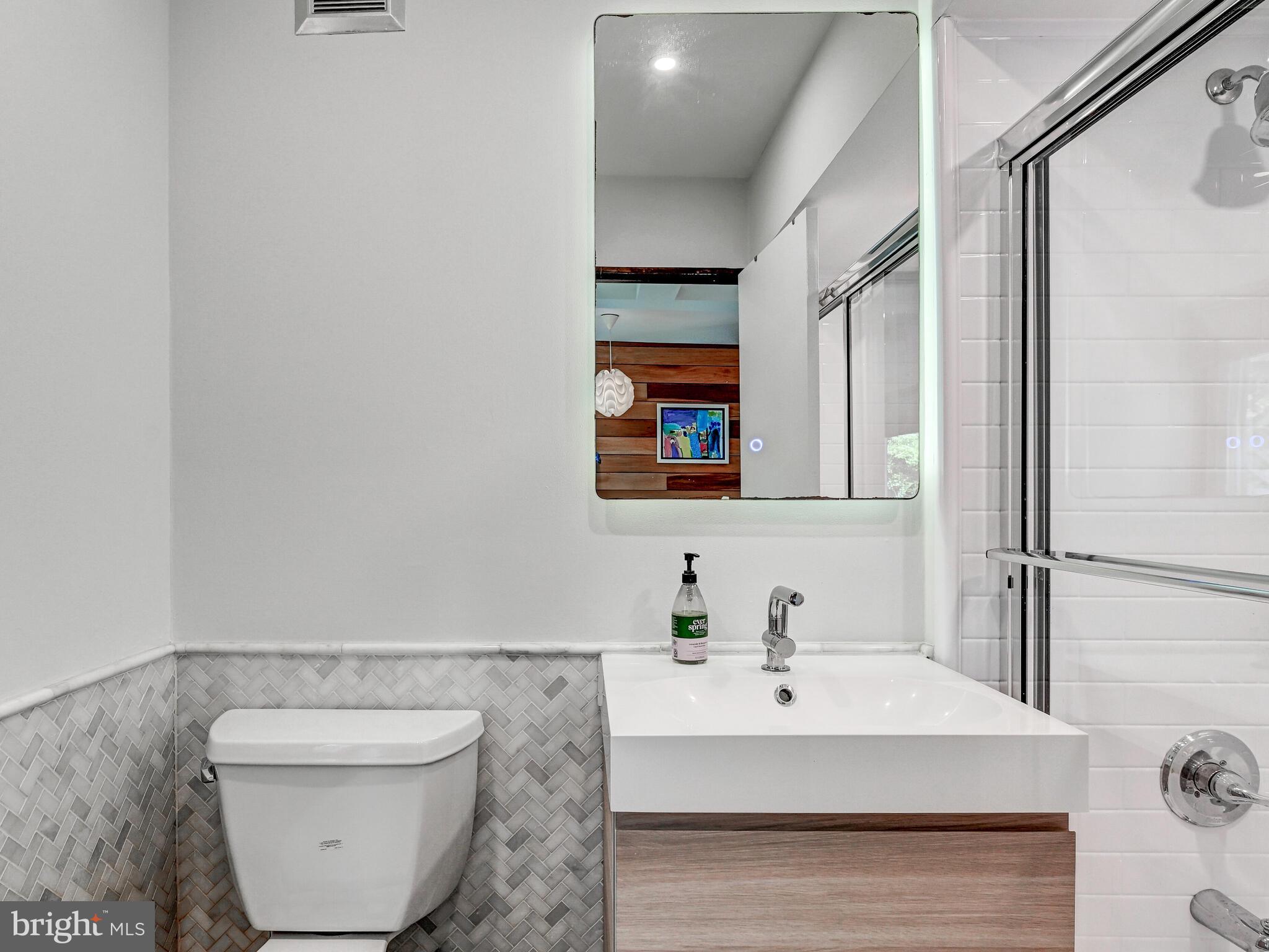 2025 Skyline Road Towson, MD 21204 - Photo 25 of 38 a bathroom with a sink toilet and mirror