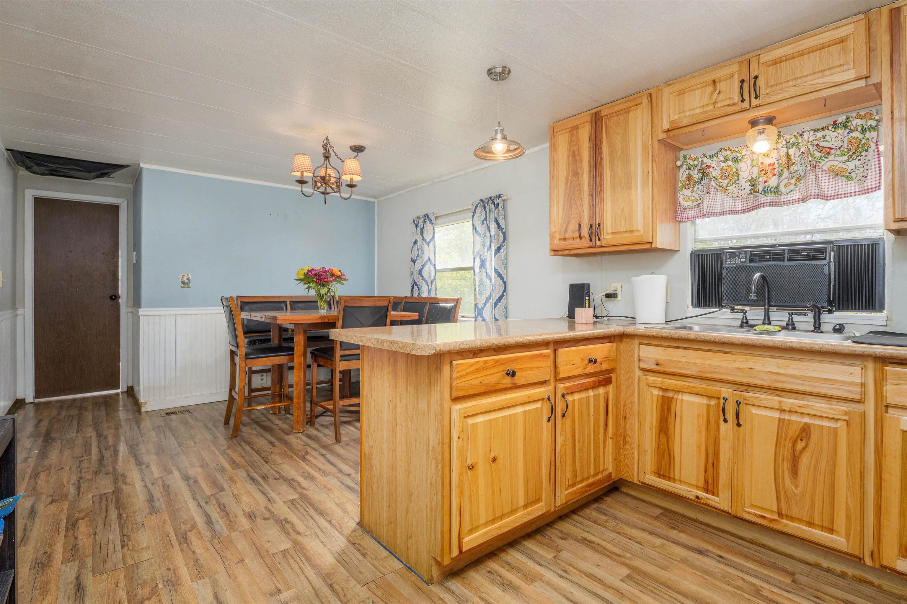265 Southwest 11th Avenue Cedaredge, CO 81413 - Photo 12 of 39 a kitchen with stainless steel appliances granite countertop a sink dishwasher and cabinets with wooden floor