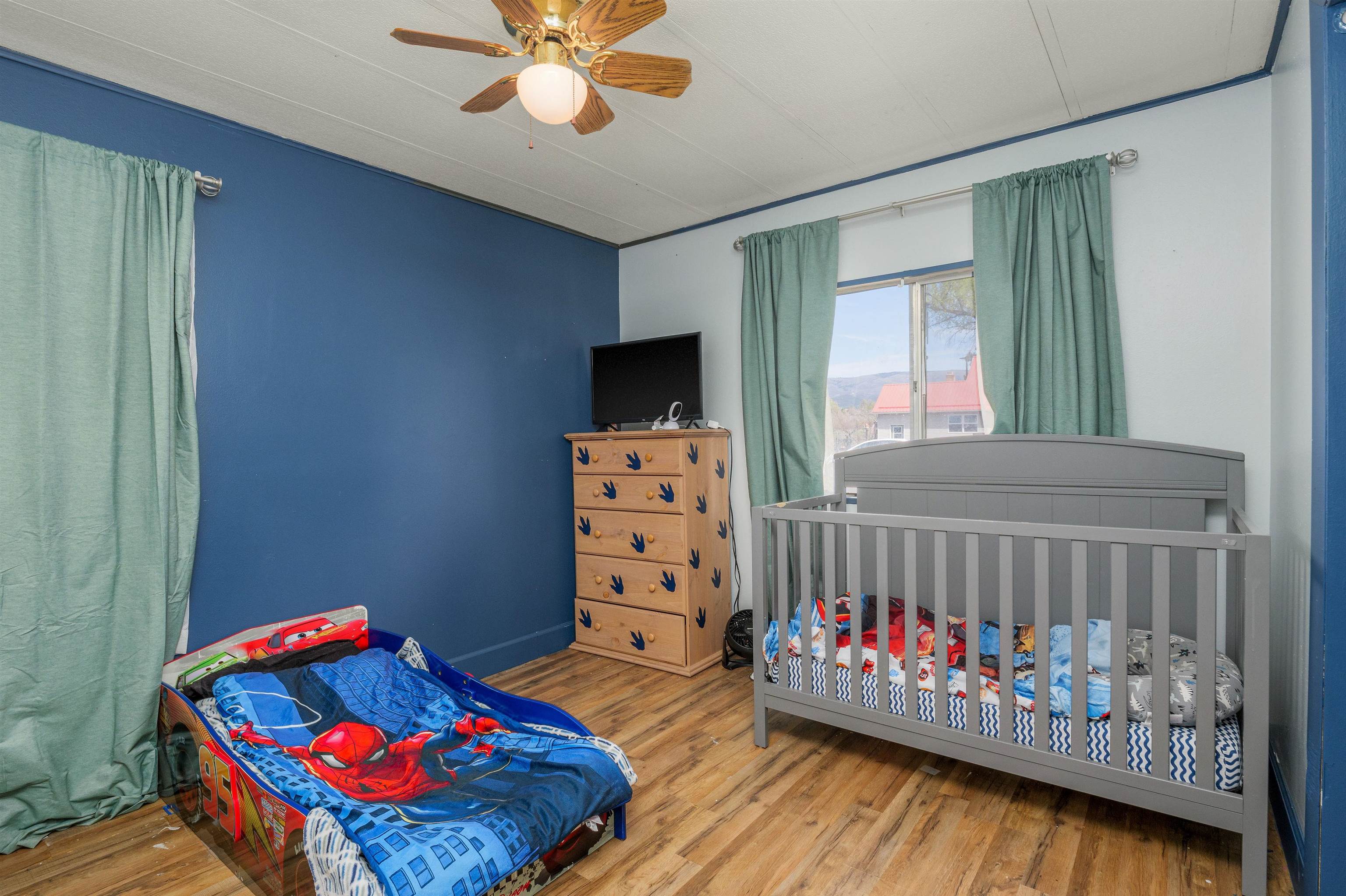 265 Southwest 11th Avenue Cedaredge, CO 81413 - Photo 16 of 39 a bedroom with furniture and a baby crib