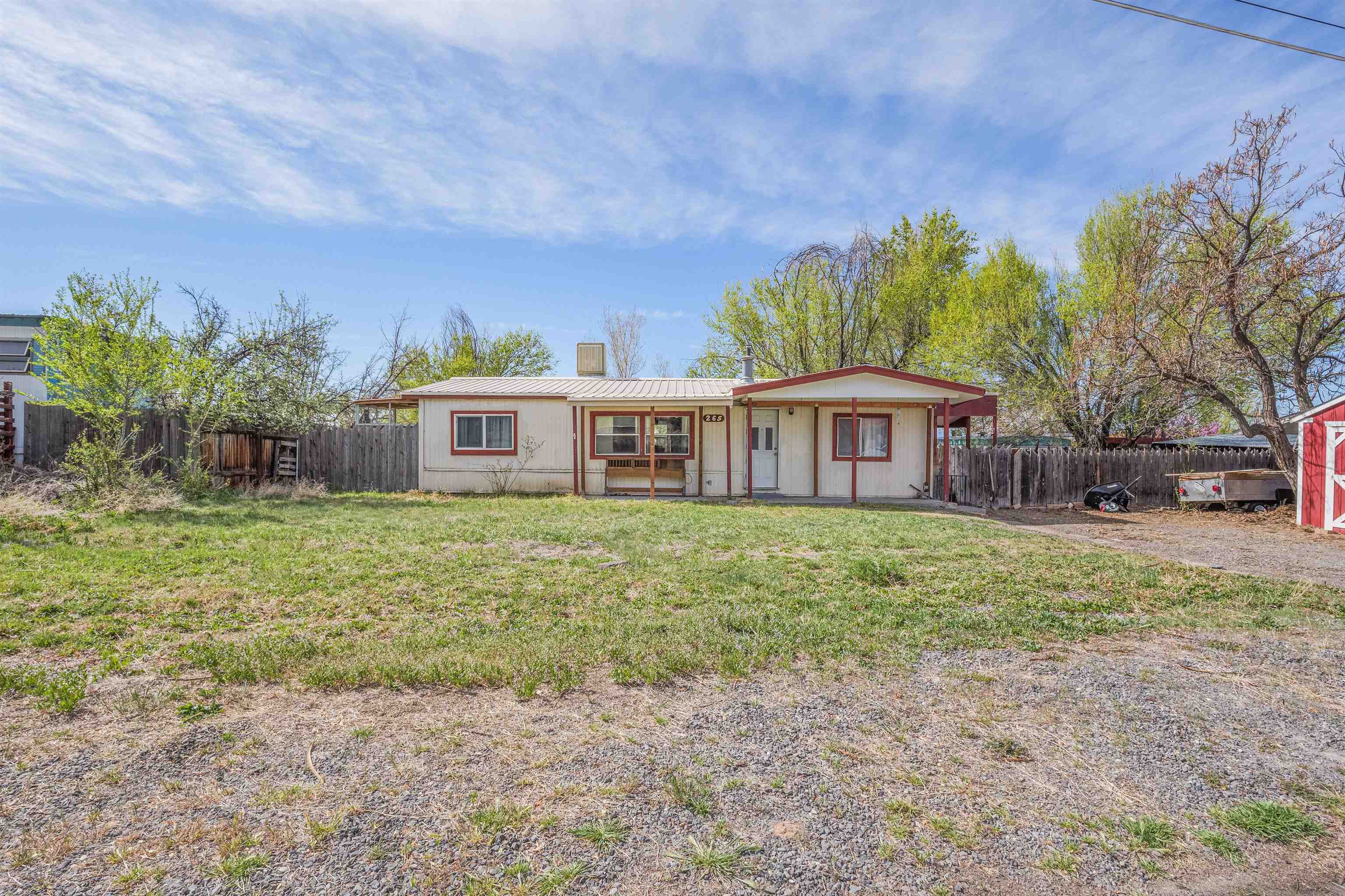 265 Southwest 11th Avenue Cedaredge, CO 81413 - Photo 2 of 39 a front view of house with yard and trees around