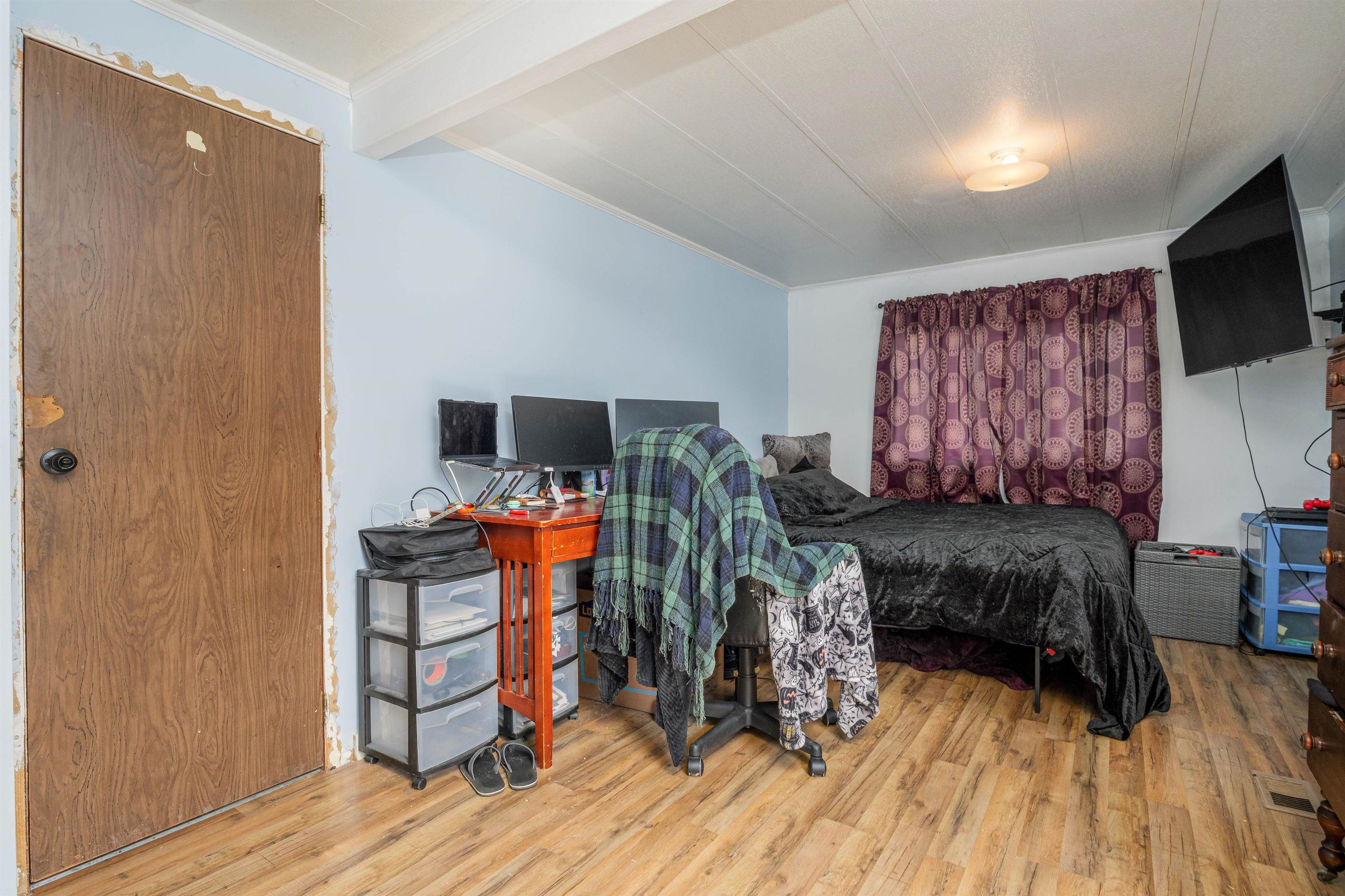 265 Southwest 11th Avenue Cedaredge, CO 81413 - Photo 21 of 39 a bedroom with furniture and a flat screen tv