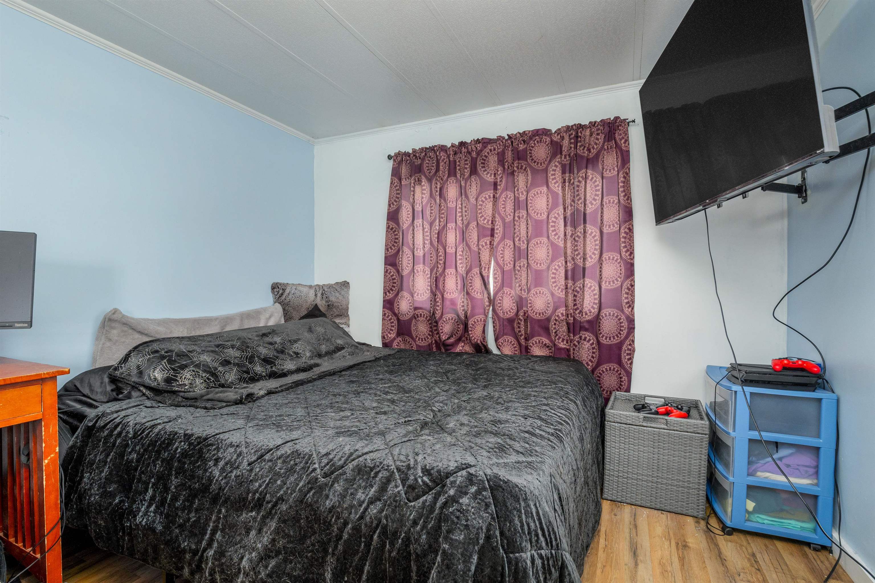 265 Southwest 11th Avenue Cedaredge, CO 81413 - Photo 22 of 39 a bedroom with a bed and flat screen tv