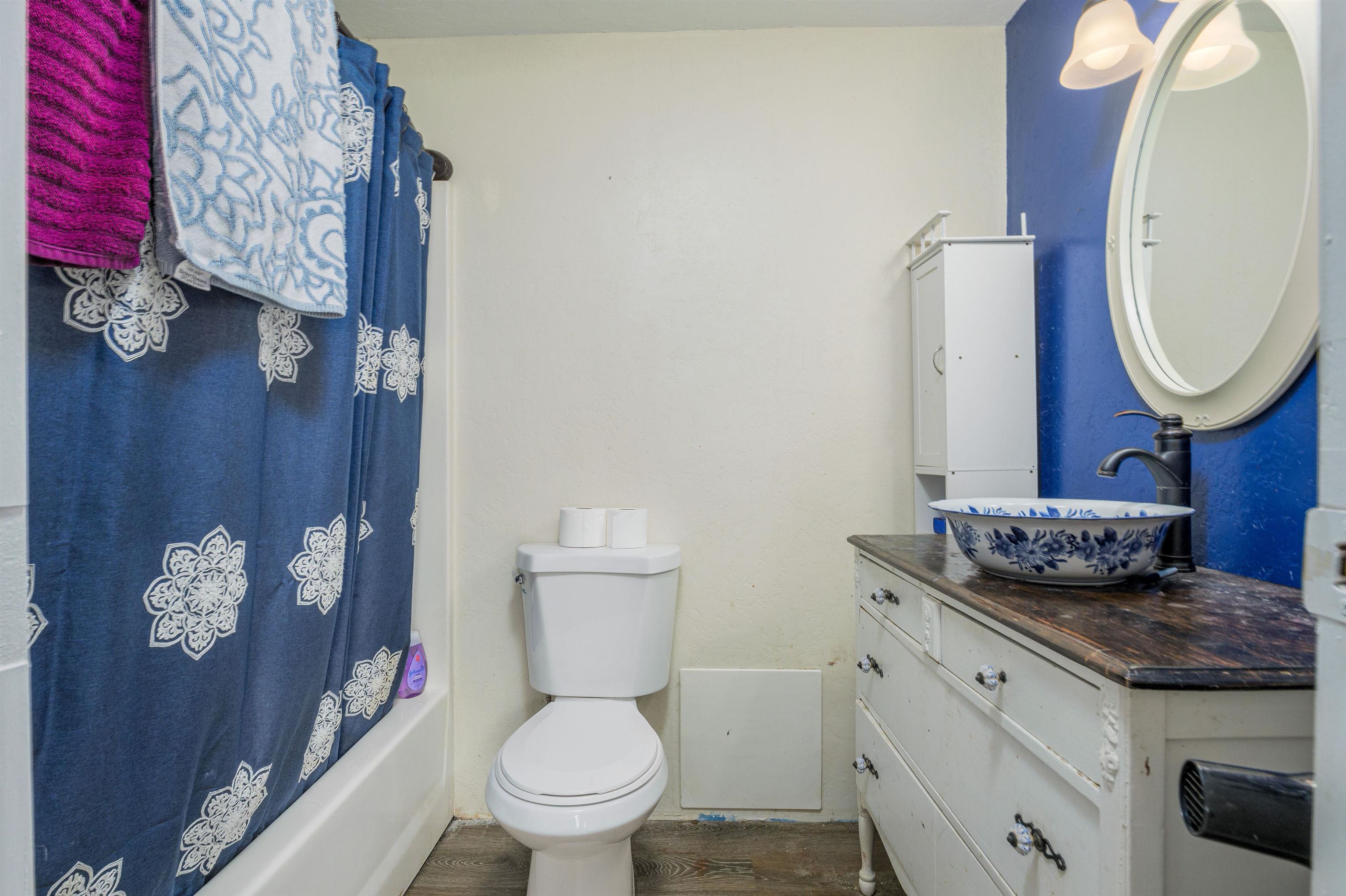 265 Southwest 11th Avenue Cedaredge, CO 81413 - Photo 26 of 39 a bathroom with a granite countertop toilet sink and mirror
