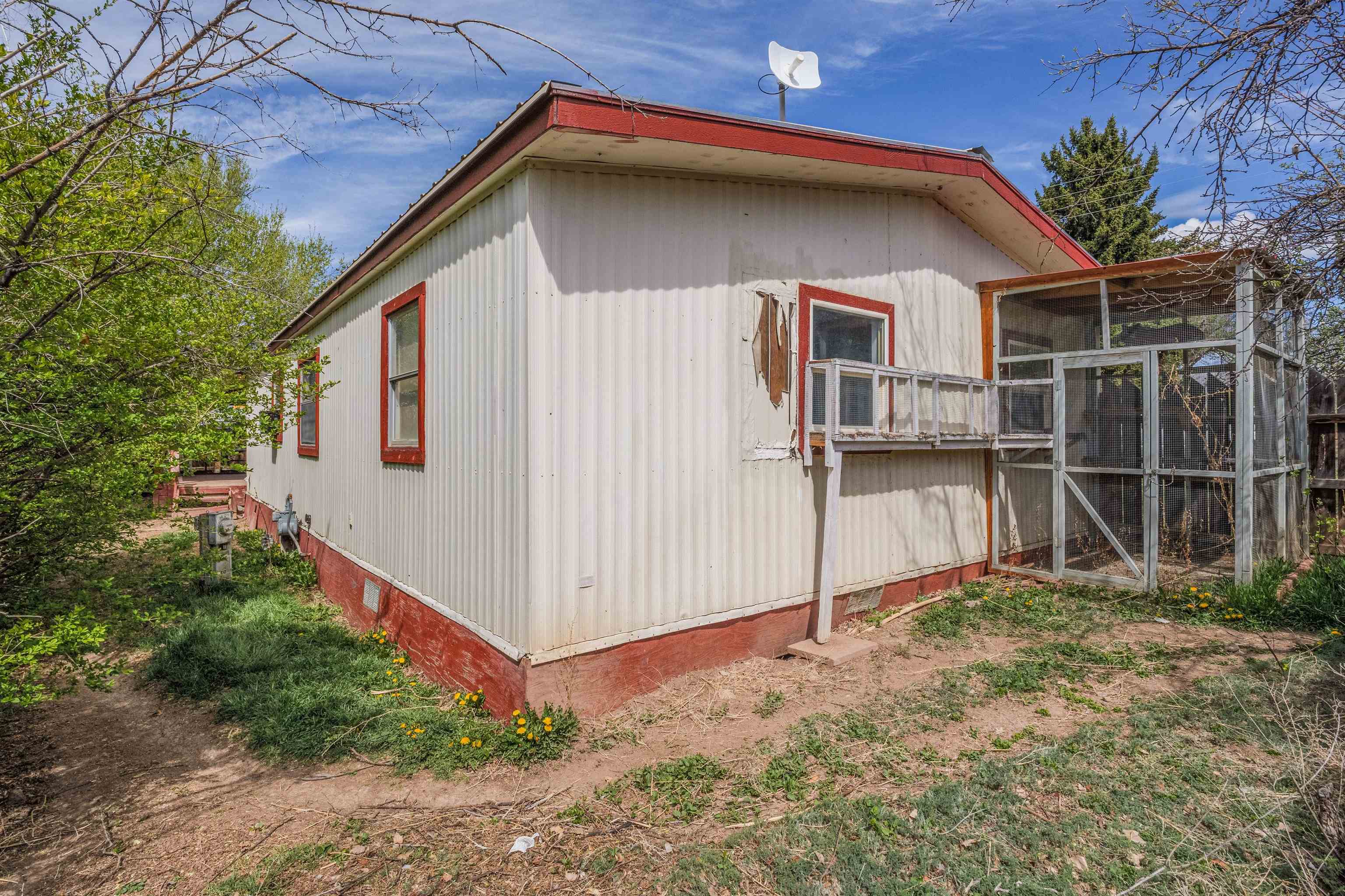 265 Southwest 11th Avenue Cedaredge, CO 81413 - Photo 36 of 39 a backyard of a house with plants and trees