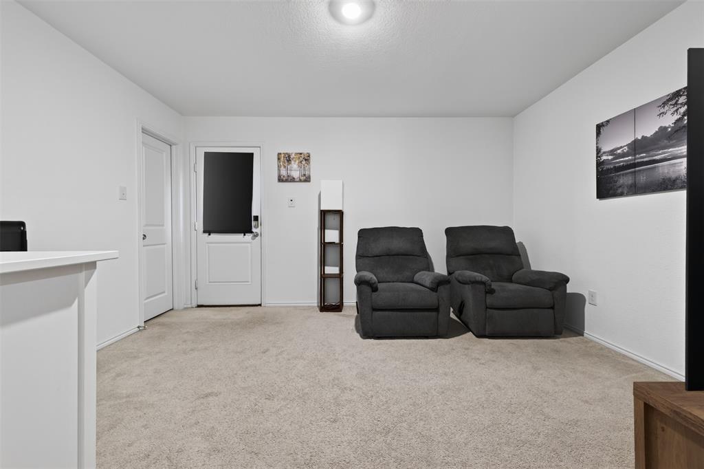 464 Reverie Way Ferris, TX 75125 - Photo 24 of 36 Neutral tone wall finishes, carpeting, and a flush-mount ceiling light