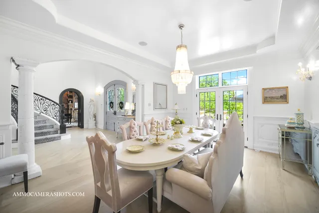 a large white kitchen with kitchen island a sink a center island stainless steel appliances and a cabinets