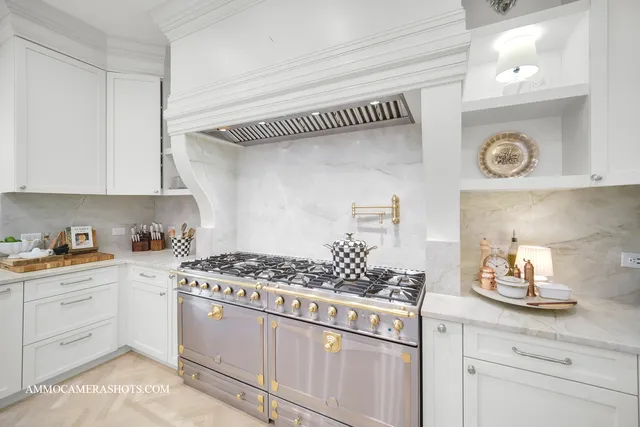 a spacious bedroom with furniture and a chandelier