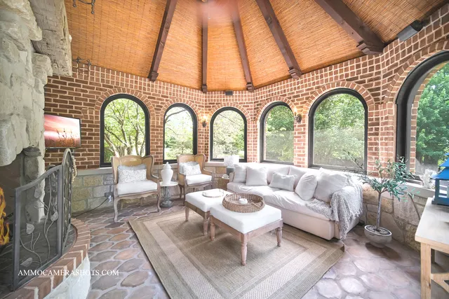 a living room with couches chairs and wooden floor