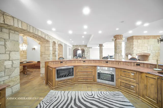 a view of a patio with table and chairs with wooden fence