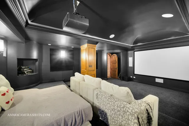 a front view of a house with a yard and fountain in middle of green field