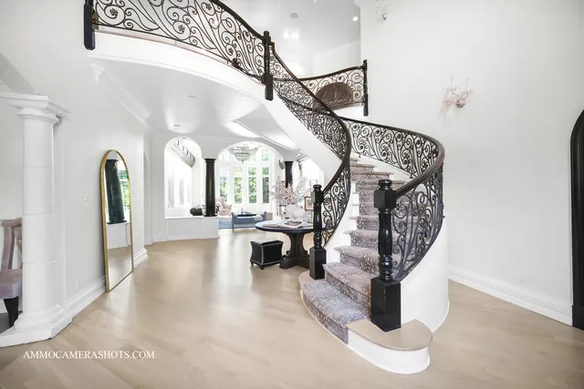 a view of a hallway with entryway wooden floor and front door