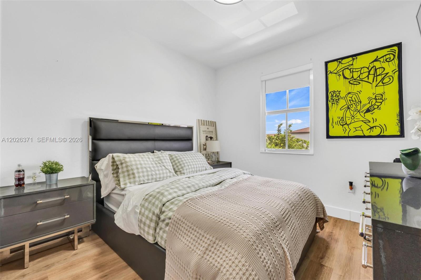 2273 Northwest 131st Circle Miami, FL 33167 - Photo 22 of 46 a bedroom with a bed and painting on the wall