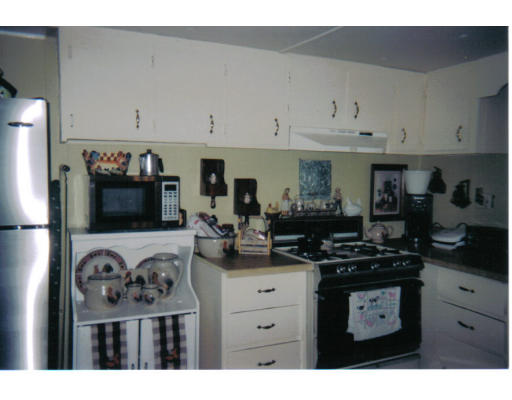 557-39 Southwest Cutoff Worcester, MA 01607 - Photo 6 of 8 a kitchen with a refrigerator and a stove
