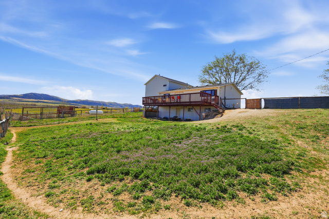 830 North Stone Road Snowville, UT 84336 - Photo 37 of 69 Rear view of property with a fenced backyard, a deck with mountain view, and a rural view