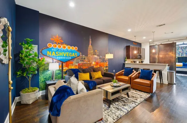 a living room with furniture kitchen and a potted plant