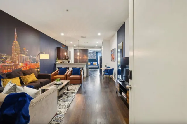 a living room with furniture and a wooden floor
