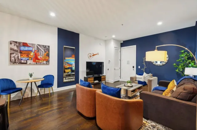a living room with furniture and wooden floor