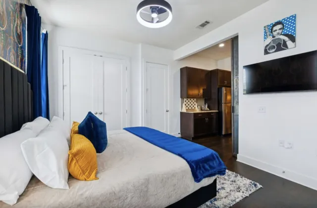 a bedroom with a bed and a television