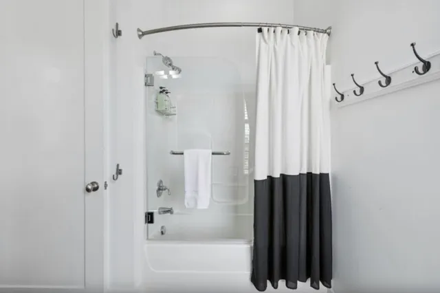 a bathroom with a shower and a tub
