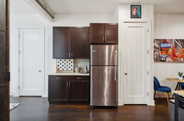 a kitchen with stainless steel appliances granite countertop a refrigerator and a stove top oven