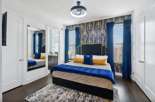 a bedroom with a bed and wooden floor