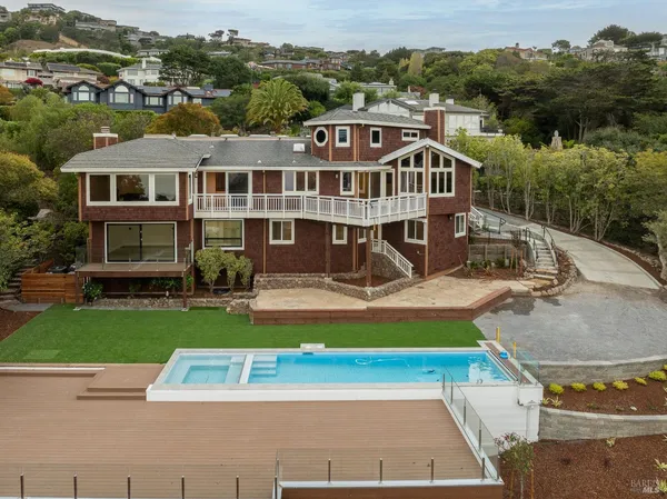 an aerial view of a house with a yard