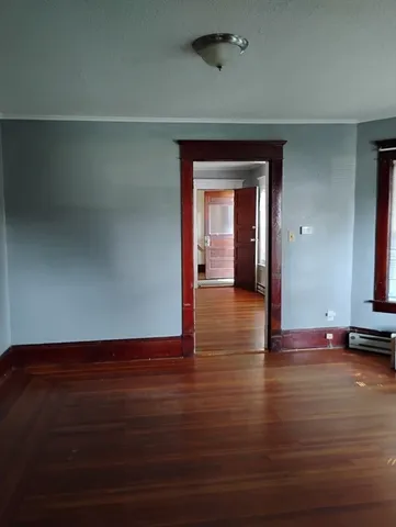 a view of room with window and wooden floor
