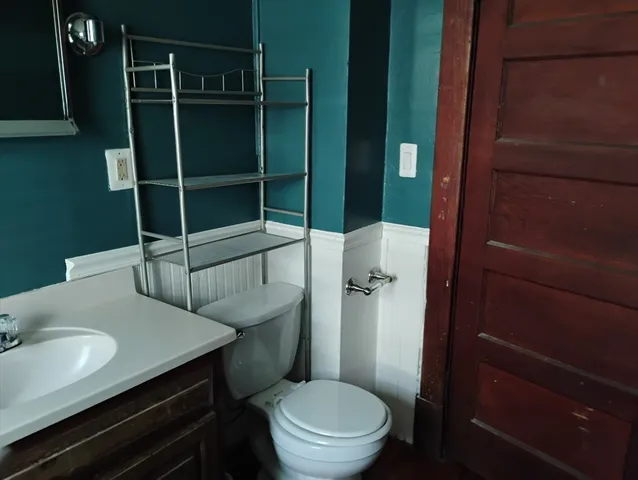 a bathroom with a toilet a sink and shower