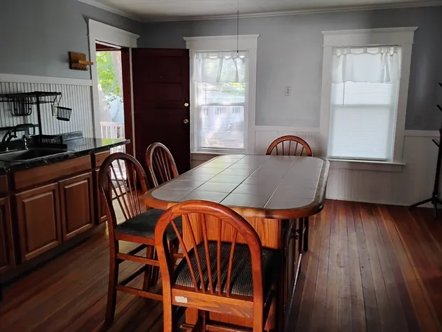 a dining room with furniture and wooden floor