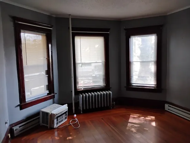 a view of a room with gym equipment and a large window