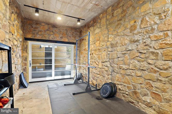 2347 South Arlington Ridge Road Arlington, VA 22202 - Photo 27 of 42 Rustic gym with stone walls.