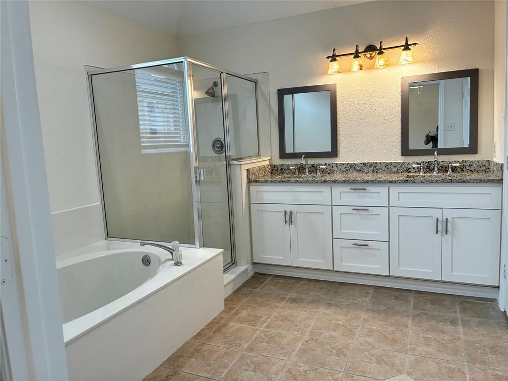 7936 Tournament Road Frisco, TX 75035 - Photo 14 of 28 a bathroom with a bathtub sink and mirror