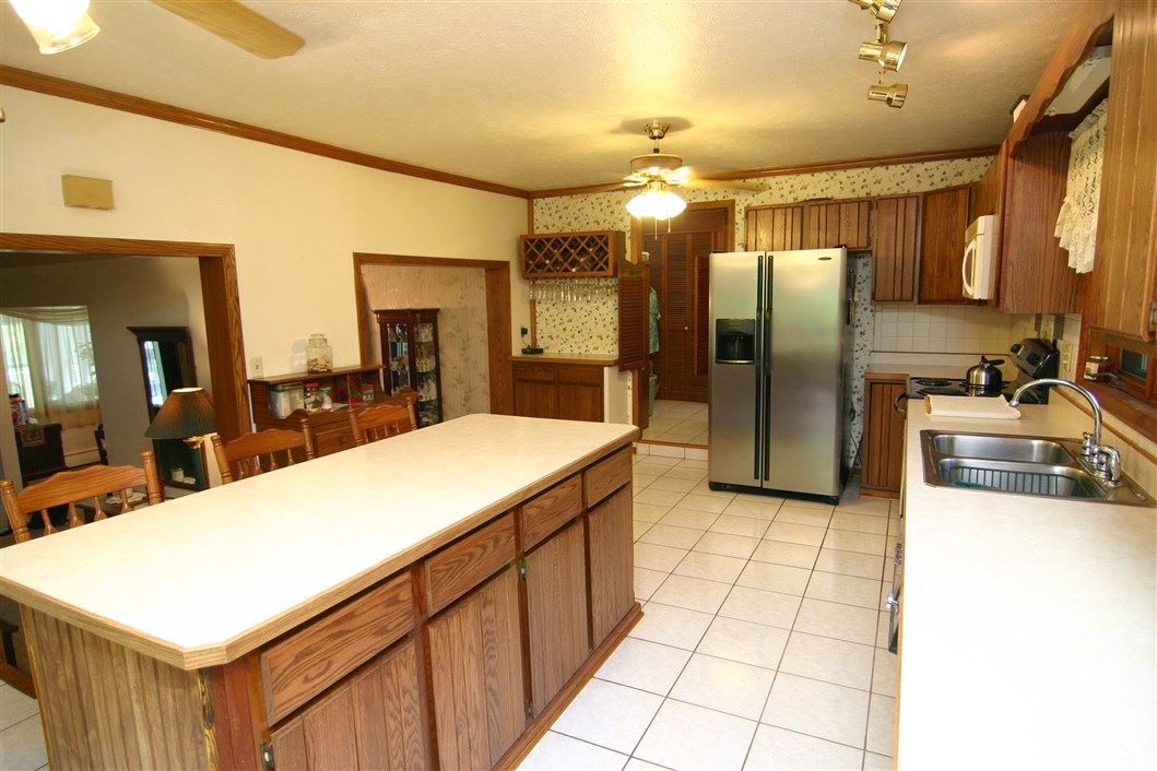 5969 Fitzgerald Road Rockford, IL 61102 - Photo 12 of 25 a kitchen with stainless steel appliances a sink and a refrigerator