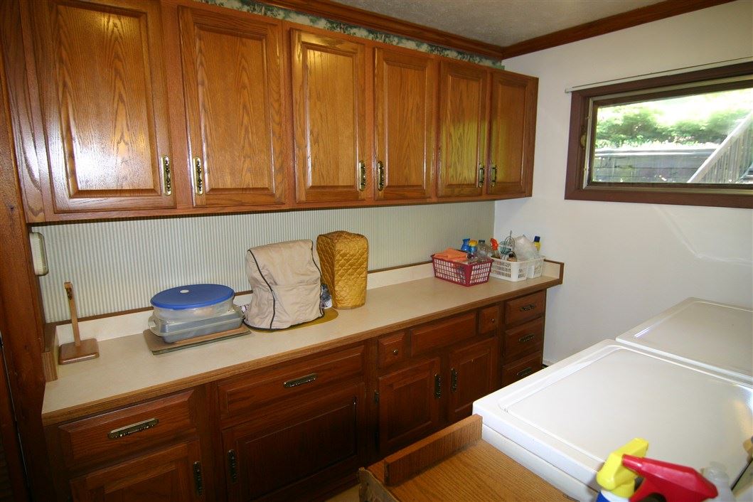 5969 Fitzgerald Road Rockford, IL 61102 - Photo 14 of 25 a kitchen with cabinets and window