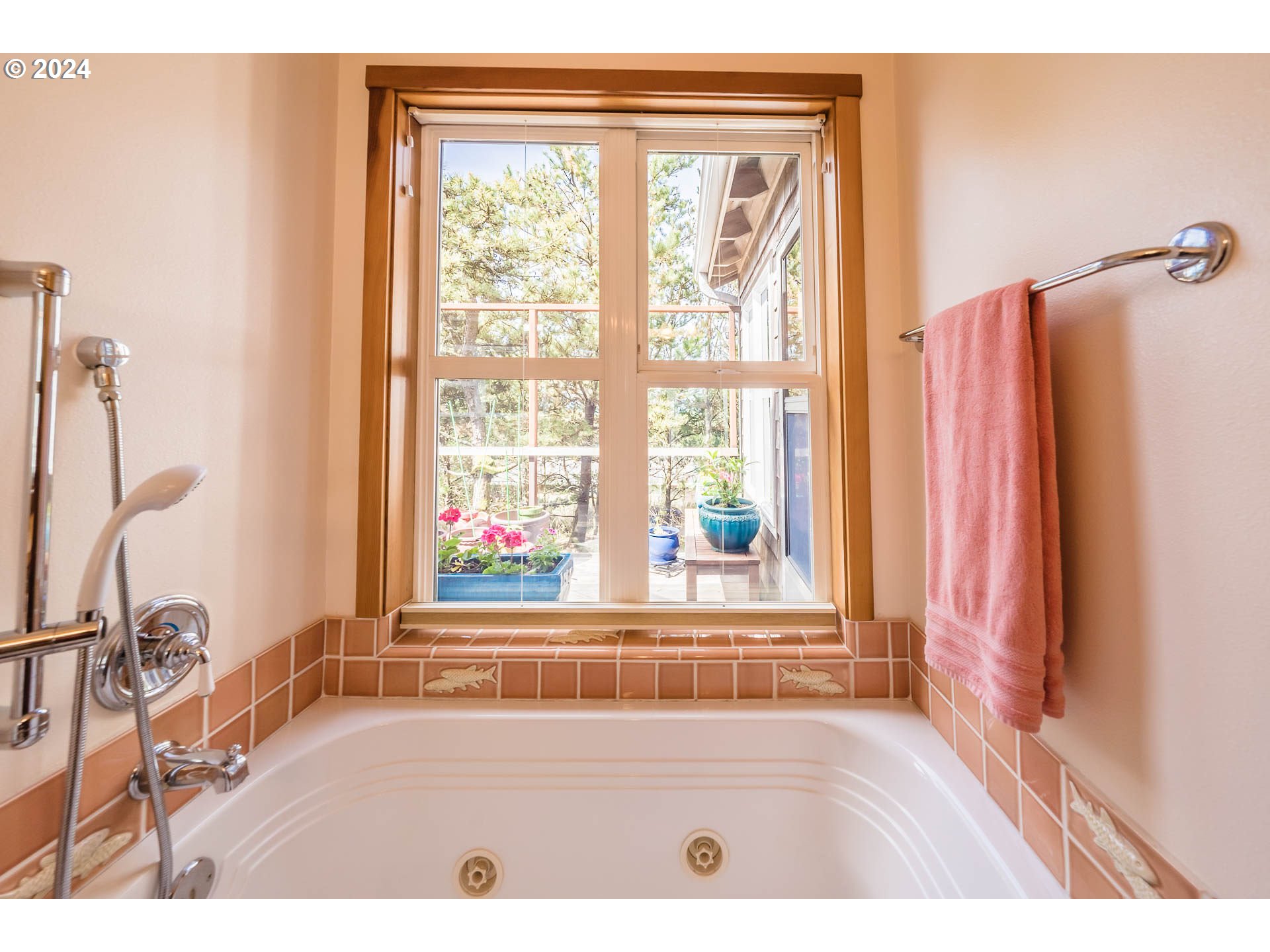 Ridge Road Pacific City, OR 97135 - Photo 28 of 34 a view of a bath tub sitting in a bathroom next to a window