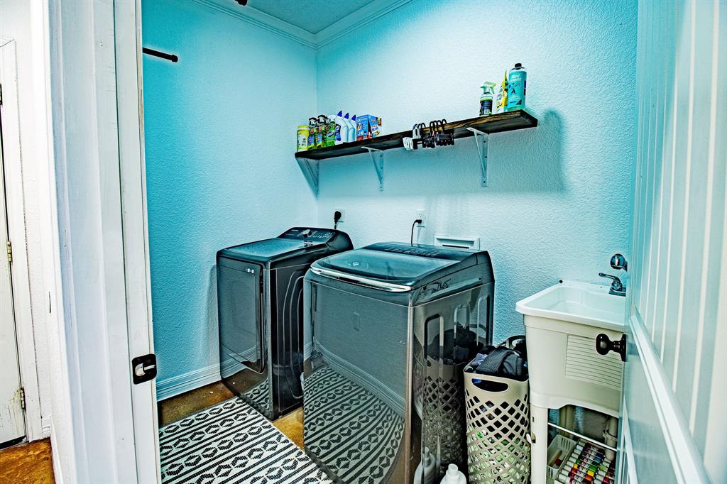 328 Meadow Lane Red Oak, TX 75154 - Photo 19 of 35 Laundry area with a textured wall, washer and clothes dryer, and ornamental molding
