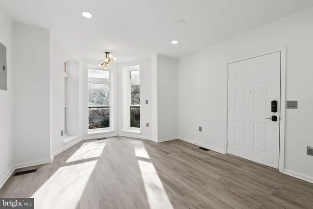 a kitchen with a refrigerator and a stove top oven