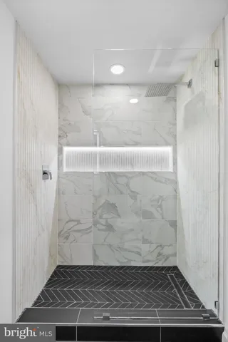 a bedroom with a large bed and paintings on the wall