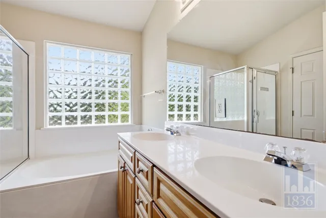 a bathroom with a granite countertop sink and a large mirror