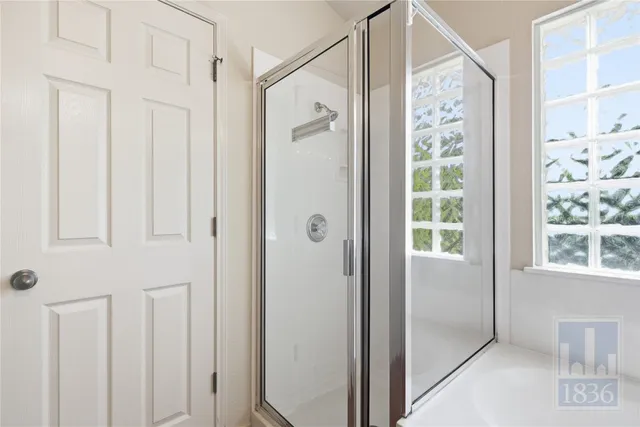 a bathroom with a shower and a sink