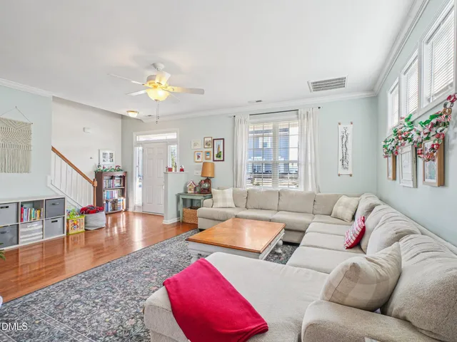a living room with furniture and wooden floor