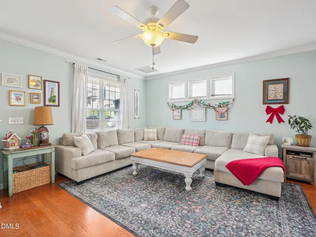 a living room with furniture and a chandelier