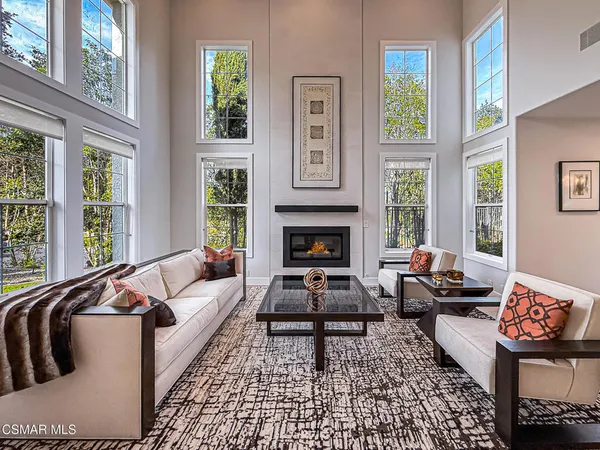 a dining room with furniture a rug and a chandelier