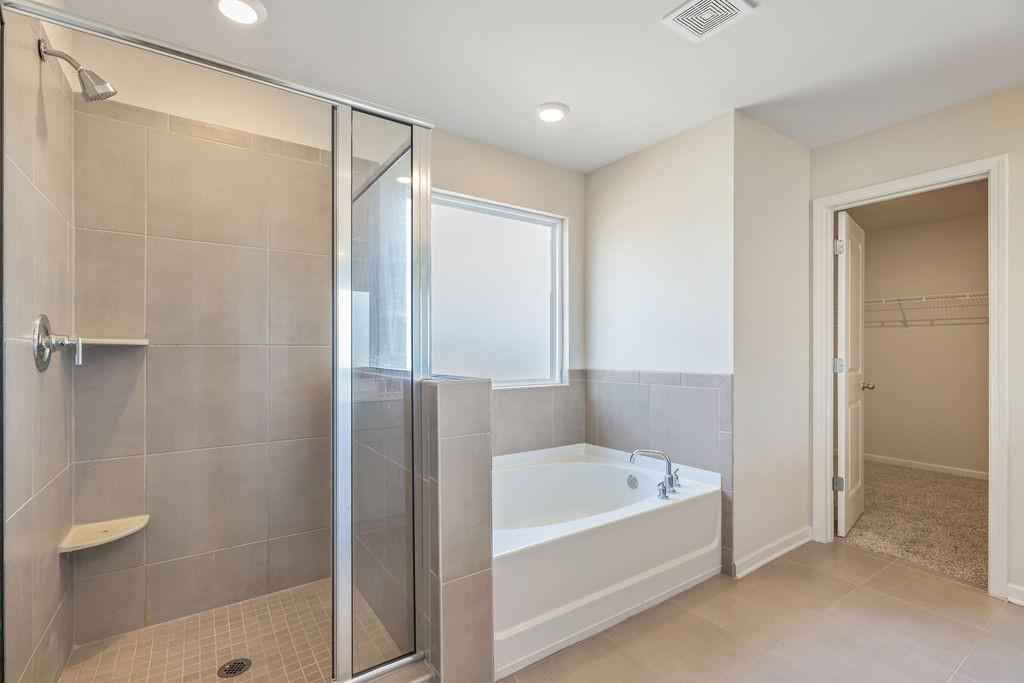 6901 Durham Lane Fairburn, GA 30213 - Photo 13 of 28 a bathroom with a bathtub and a shower