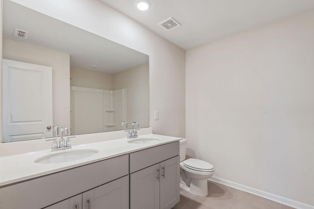 6901 Durham Lane Fairburn, GA 30213 - Photo 19 of 28 a bathroom with a double vanity sink and a mirror