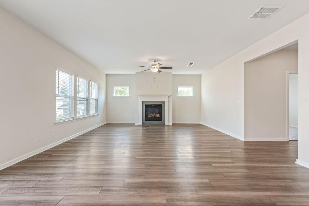 6901 Durham Lane Fairburn, GA 30213 - Photo 3 of 28 a view of a livingroom with wooden floor and a fireplace