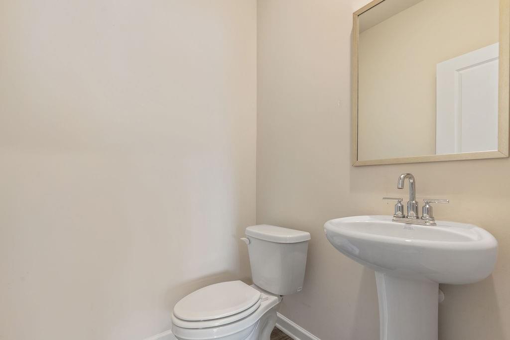 6901 Durham Lane Fairburn, GA 30213 - Photo 7 of 28 a bathroom with a sink a toilet and mirror