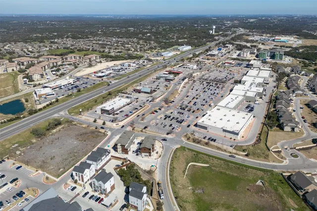 an aerial view of a residential houses with outdoor space